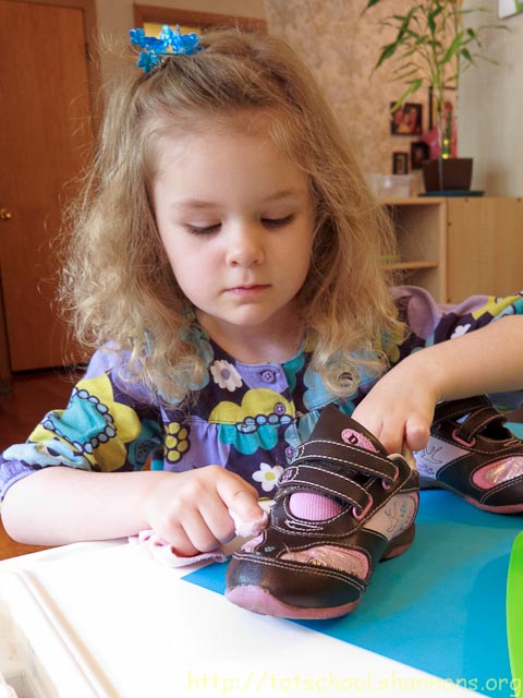 child polishing shoes